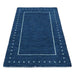 Low-angle view of the full rectangular blue rug on a white background