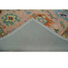 Turned rug corner showing the gray backing