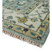 Rug corner close-up with floral border, bound edge, and fringe