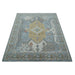 Full traditional hand knotted wool rug with fringed near edge shown at a shallow frontal angle