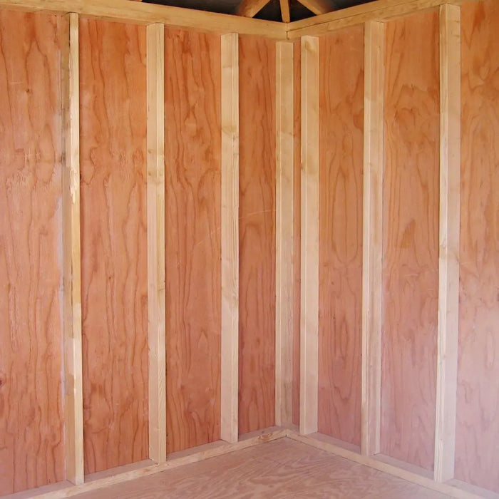 Little Cottage Co. 10x10 Classic Five-Corner Shed interior view showing framed wall studs and plywood wall panels in unfinished wood interior