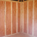 Little Cottage Co. 10x10 Classic Five-Corner Shed interior view showing framed wall studs and plywood wall panels in unfinished wood interior