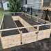 Outdoor Living Today 8x16 cedar raised garden bed with soil in a backyard setting