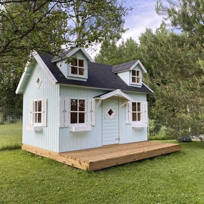 Small green palmako marie 9x6 playhouse kit with a wooden deck in a grassy area with trees.