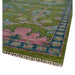 Angled view of a rug corner and fringe