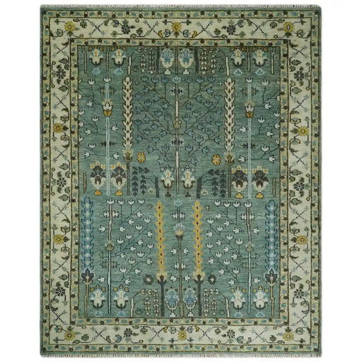 Aqua Green and Ivory 8x10 rectangular wool rug with a bordered floral and geometric field and fringe on a light background.