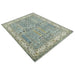 Angled full view of the aqua and ivory rectangular rug