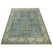 Low-angle view across the aqua and ivory rectangular rug