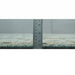 Side profile of the hand-knotted wool rug beside a ruler