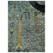 Styled close view of the aqua and ivory tree motif rug beneath a table leg
