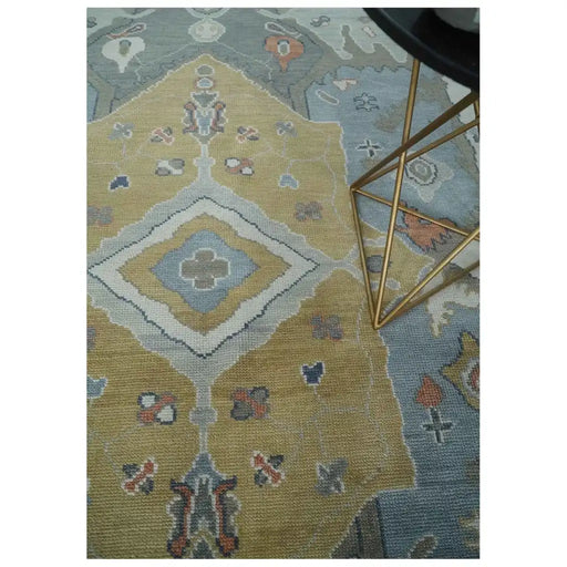 Central geometric medallion on beige, blue and ivory hand knotted wool area rug
