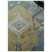 Central geometric medallion on beige, blue and ivory hand knotted wool area rug