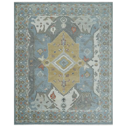 Beige, blue and ivory hand knotted wool rug with blue border and central beige geometric medallion