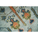 Macro view of blue-gray, rust, and muted accent motifs across the rug pile