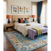 Blue and ivory Oushak rug displayed in a bedroom