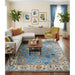 Blue and ivory Oushak rug displayed in a living room