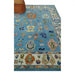 Blue and ivory Oushak rug displayed in a furnished room