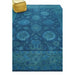 Angled floor view of a blue Oushak rug with a yellow pouf