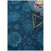 Overhead close-up of a blue Oushak rug styled with a small table and plant