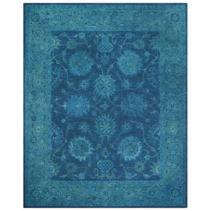Full front view of a blue traditional Oushak wool rug on a white background