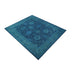 Wide angled view of the full blue Oushak rug on a white background