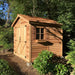 Angled exterior view of the Cedarshed Rancher cedar storage shed with windows and garden plants