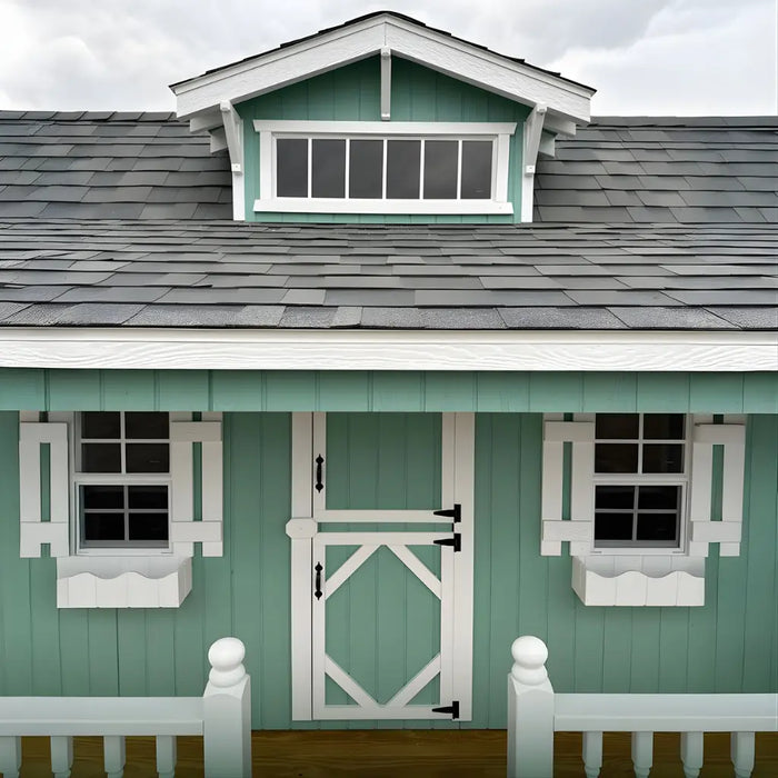 Little Cottage Co Craftsman Playhouse Kit with white trim and a small door, set against a cloudy sky.