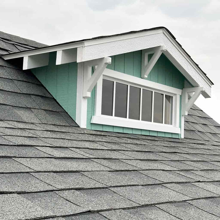 Little Cottage Co Craftsman Playhouse  with green dormer window with white trim on the roof