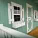 Little Cottage Co Craftsman Playhouse Kit with white window and door shutters 