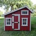 EZ-Fit 7x6 Playhouse Kit  in red with white trim on a grassy area with trees in the background