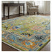 Green, Gray and Peach Oushak rug shown in a furnished room with a desk and armchair.