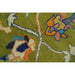 Close-up of multicolored motifs on the green field of the Oushak rug.