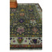 Angled partial view of the green rug with an ivory floral border