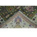 Floral border and corner detail on the green and ivory Oushak rug