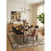 Green and ivory traditional Oushak rug staged beneath a dining table