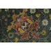 Colorful floral motifs on the dark green field of the hand knotted rug