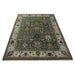 Low perspective full view of the green and ivory Oushak area rug on a plain background