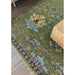 Cropped rug corner beside a wood furniture leg