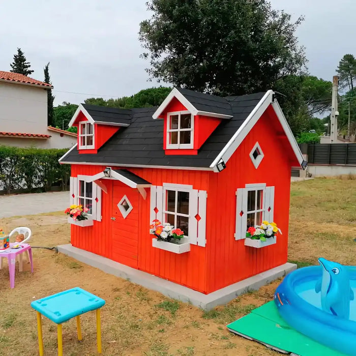 Red palmako marie 9x6 wood playhouse kit with black roof in a backyard setting