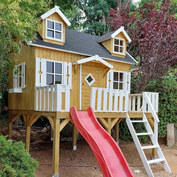 Wooden palmako marie 9x6 playhouse with a red slide and white ladder in a garden setting side view