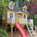 Wooden palmako marie 9x6 playhouse with a red slide and white ladder in a garden setting side view