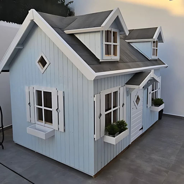 Blue palmako marie 9x6 children's playhouse with white trim and rooftop dormer windows on a gray pavement