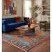 Lifestyle view of rug partly placed under furniture