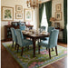 Hand-knotted rug staged beneath a dining table and chairs