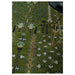 Olive green rug field with blue, beige, and black botanical motifs beside a stool