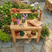 Outdoor Living Today 4x2 Cedar Potting Bench top view with pots, tools, and plants on a stone patio