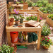 OLT 4x2 Cedar potting bench with gardening tools and plants in a garden setting