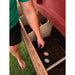 Person collecting eggs from the exterior nesting box of an OverEZ Large Chicken Coop.