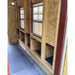 Interior detail of the Classic red OverEZ Large Chicken Coop showing roost supports and windows.