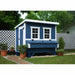 Blue Coastal OverEZ Large Chicken Coop installed beside a white lattice fence.